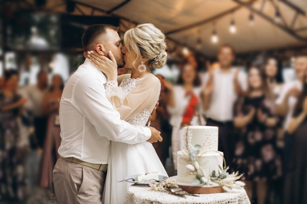 wedding-cake-bride-groom-kisses-cut-off-piece-cake-with-knife-hands-newlyweds-cut-first-piece-wedding-cake